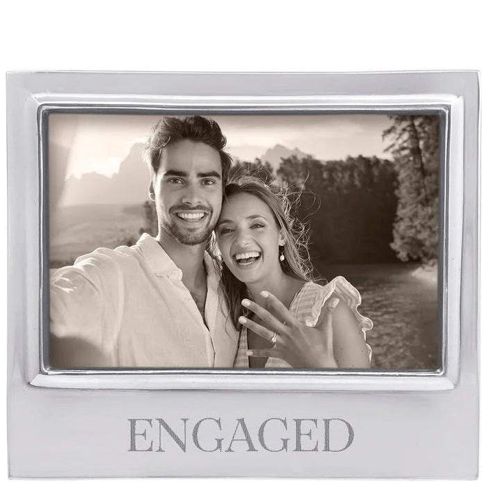 Silver photo frame with 'ENGAGED' text containing a black and white photo of a couple outdoors.