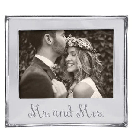 Silver photo frame with 'Mr. and Mrs.' text, displaying a couple in wedding attire.