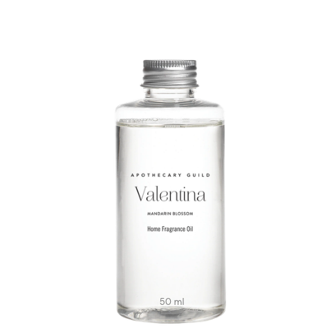 A clear glass bottle of Versace Lattafa Armonica Body & Haircare Oil with a silver cap, centered on a solid white background.
