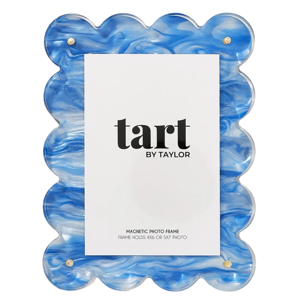 A scalloped-edge acrylic magnetic photo frame in a blue and white marbled pattern, featuring a white insert card with the brand name 'tart BY TAYLOR' printed in black.