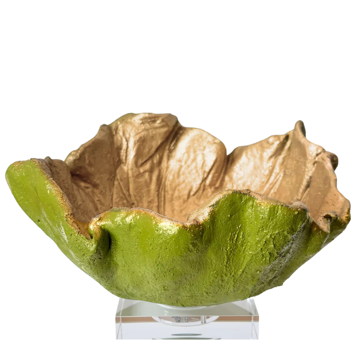A sculptural lime-shaped bowl with a textured green exterior and a metallic gold interior, displayed on a clear acrylic stand against a white background.