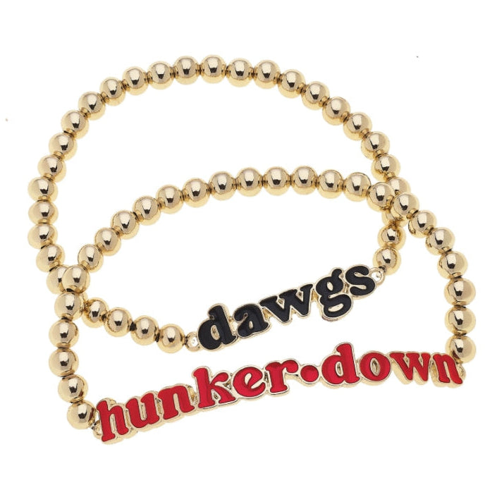 Gold beaded bracelet with 'dawgs hunker down' text on a white background