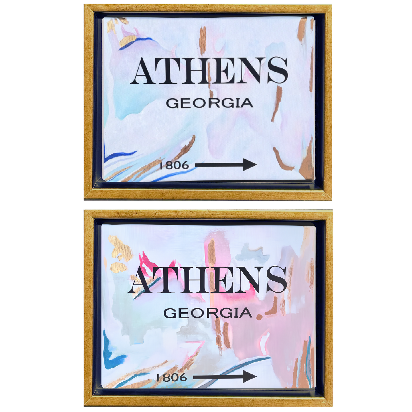 Two framed art prints featuring a watercolor-style abstract design in pastel shades of pink, blue, and white, with gold frames. Each print displays the text 'ATHENS GEORGIA' and '1806' with a directional arrow.