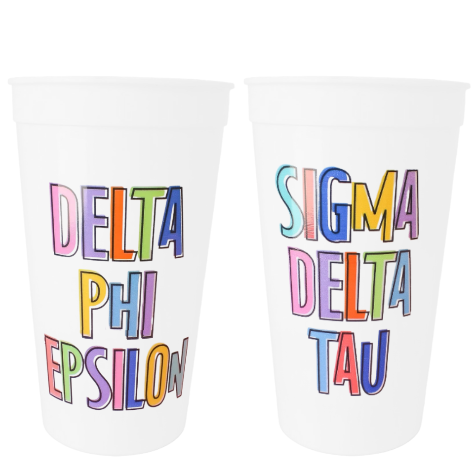 Two white plastic cups with colorful Greek lettering, one reading 'DELTA PHI EPSILON' and the other 'SIGMA DELTA TAU', on a plain white background.