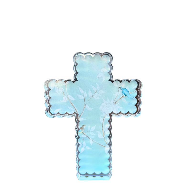 A light blue cross-shaped acrylic shelfie with a scalloped edge, shown against a plain white background.
