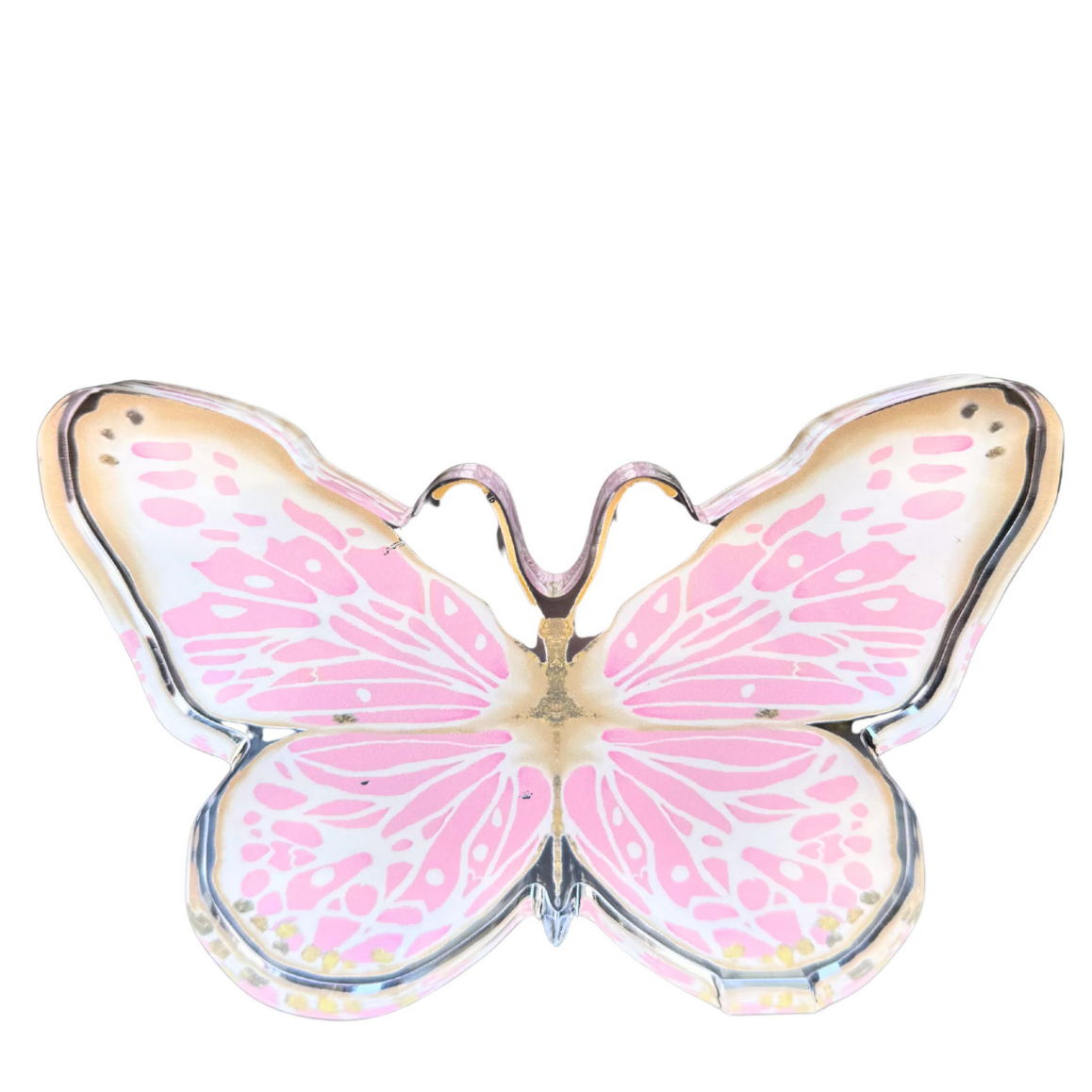 A butterfly-shaped acrylic shelfie with iridescent pink and white wings outlined in gold metal, shown against a plain white background.