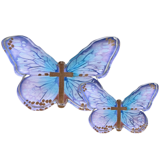 Two butterfly-shaped acrylic shelfies with translucent blue and purple wings, brown cross-shaped centers, and small gold dot accents, shown on a plain white background.
