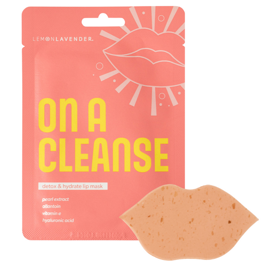 A lip-shaped beige mask in front of its coral pink and yellow packaging, labeled 'ON A CLEANSE' by Inouillavender.