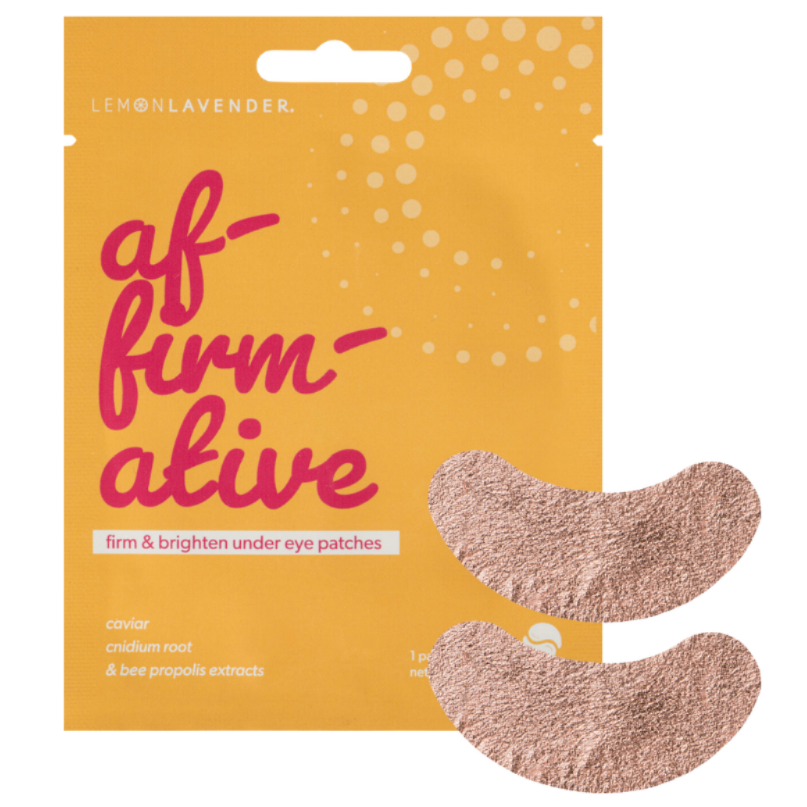 A package of af-firmative eye patches by The Lavender Room, featuring a mustard yellow pouch with pink lettering and two visible beige under-eye patches on a plain white background.