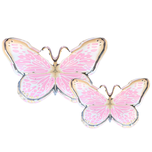 Two butterfly-shaped acrylic shelfies with pink patterned wings and gold-toned outlines, displayed on a clean white background.