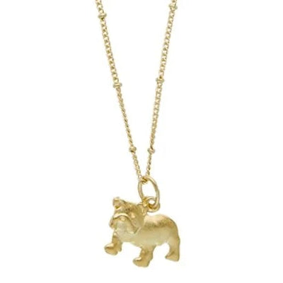 A delicate gold chain necklace featuring a small bulldog pendant, displayed against a solid white background.