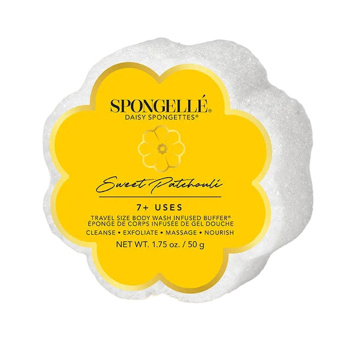 A flower-shaped Spongellé Sweet Patchouli body wash infused buffer bar, featuring a white textured outer edge and a bright yellow center label with black text, on a plain white background.