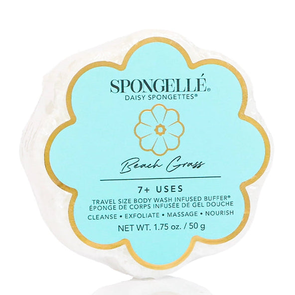 A single round sponge body sponge with a scalloped edge, wrapped in white paper and featuring a light blue and gold label that reads 'SPONGELLIE Daisy Spongettes Beach Grass'.
