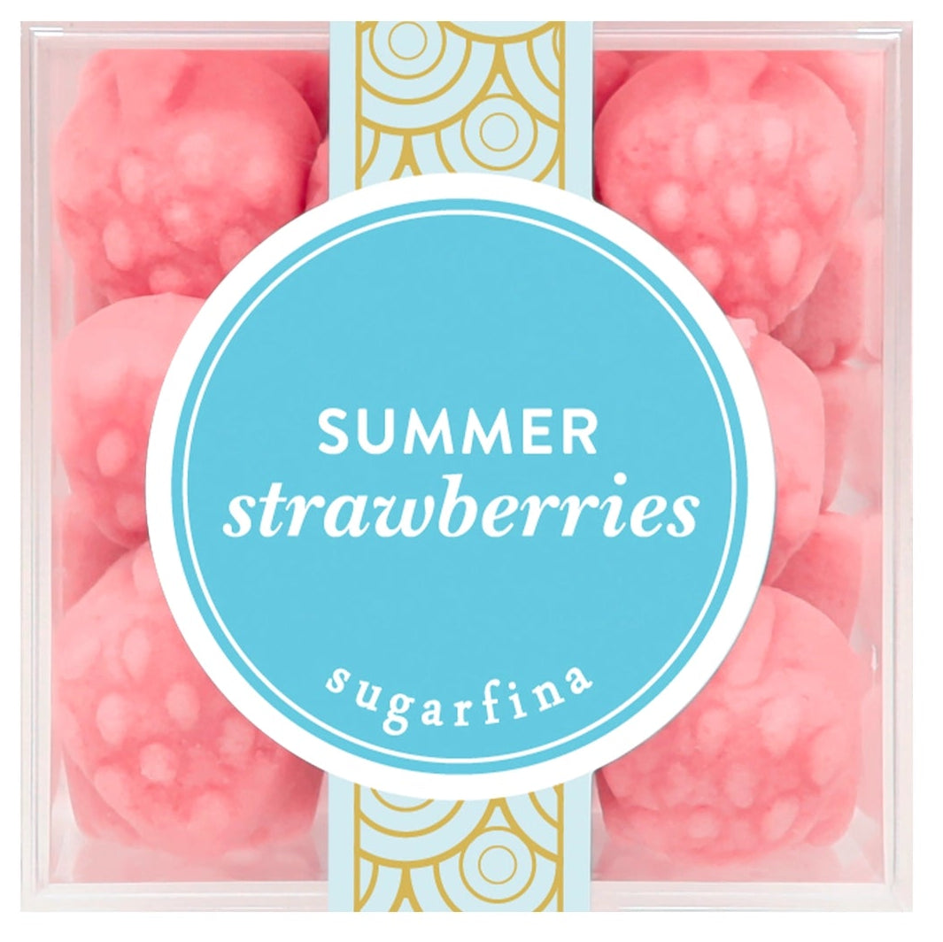 A clear square plastic box containing pink strawberry-shaped wax melts or soaps, with a central light blue oval label reading 'SUMMER strawberries' and the brand name 'sugarfina' below it. The box is photographed on a plain white background.