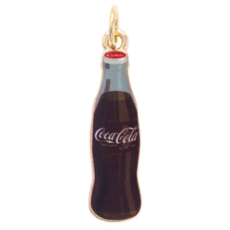 A miniature Coca-Cola bottle charm pendant with a gold-tone metal frame and cap, featuring dark brown and black enamel detailing, a light blue neck, and the white Coca-Cola script logo on the front.
