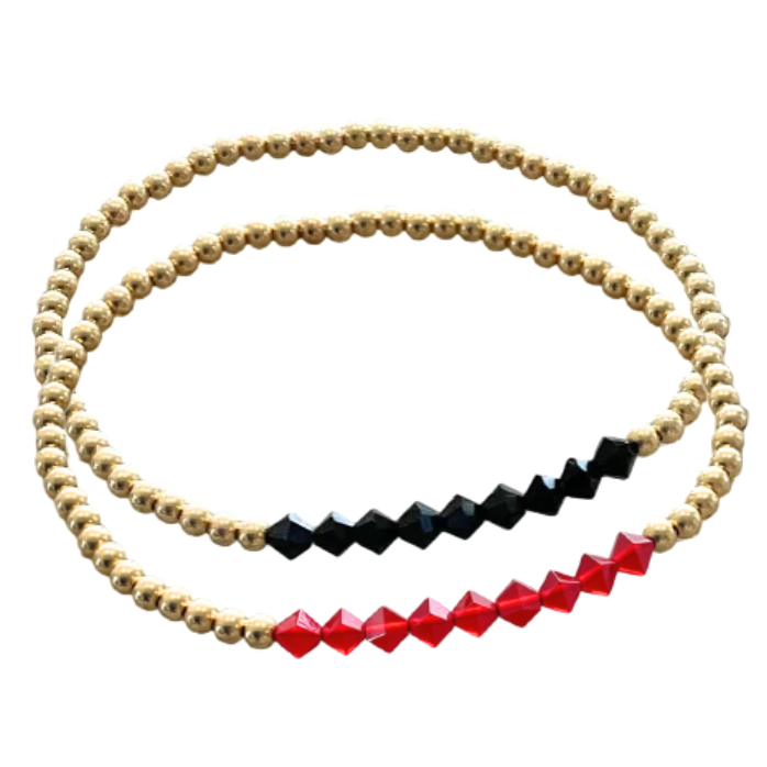 Two beaded stretch bracelets on a plain white background. One bracelet is gold with a row of faceted black beads, and the other is gold with a row of faceted red beads.
