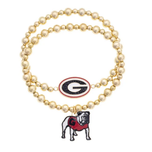 A double-strand beaded stretch bracelet in a gold tone, featuring a Georgia Bulldogs logo charm and a bulldog charm, on a plain white background.