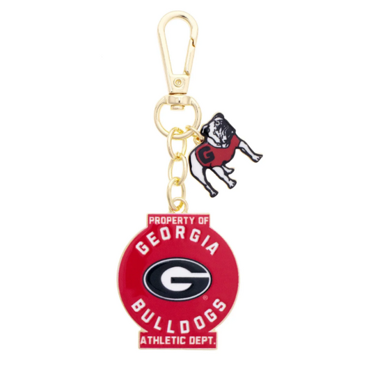 A Georgia Bulldogs keychain featuring a red circular charm with the team logo and a small black-and-red bulldog figure, attached to a gold-tone clasp on a plain white background.