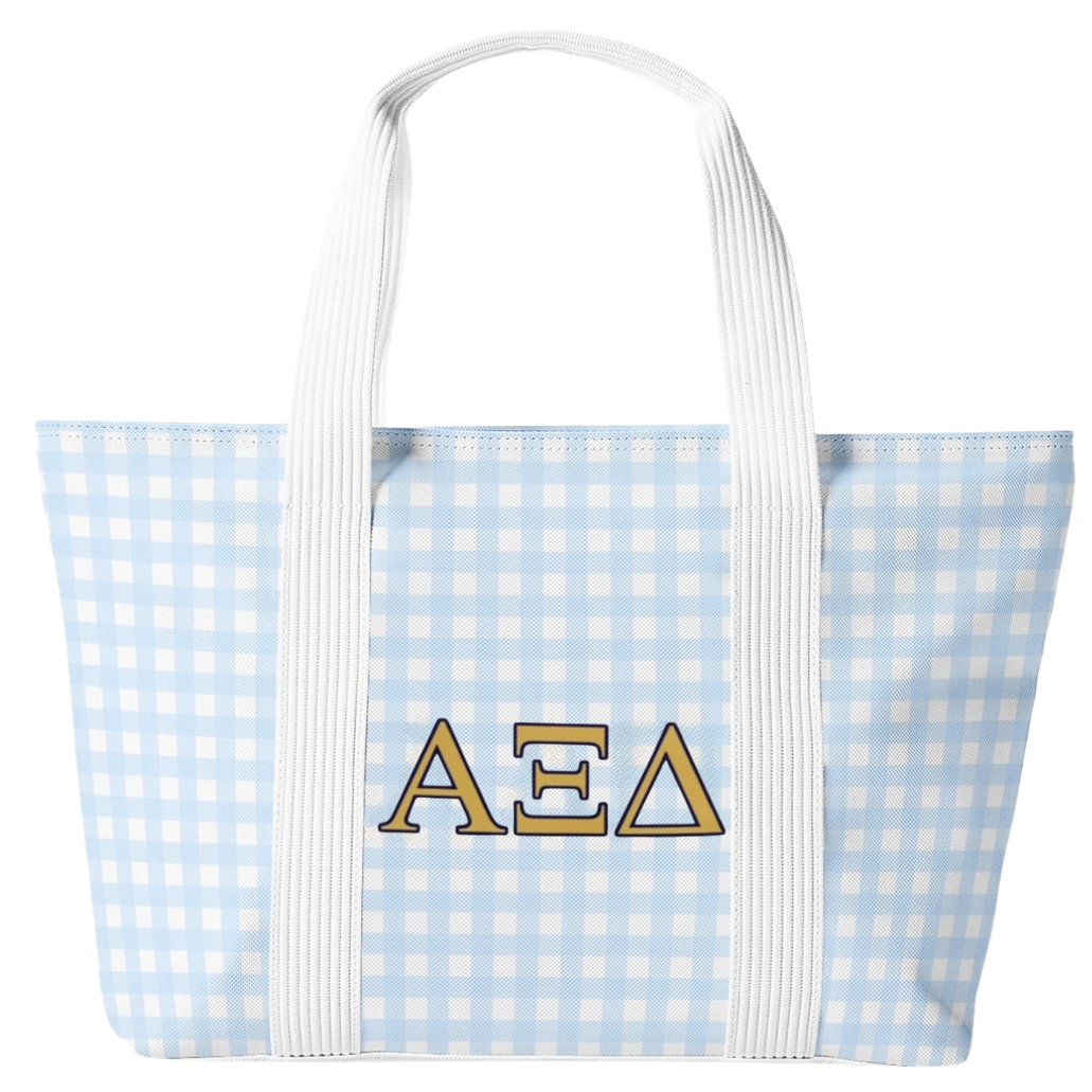 A light blue and white gingham tote bag with white shoulder straps and the Greek letters 'ΑΞΔ' embroidered in gold and white on the front, set against a plain white background.