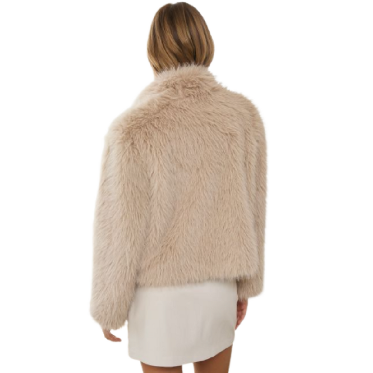 A model shown from the back wearing a beige faux fur cropped jacket and a white mini skirt, set against a plain white background.