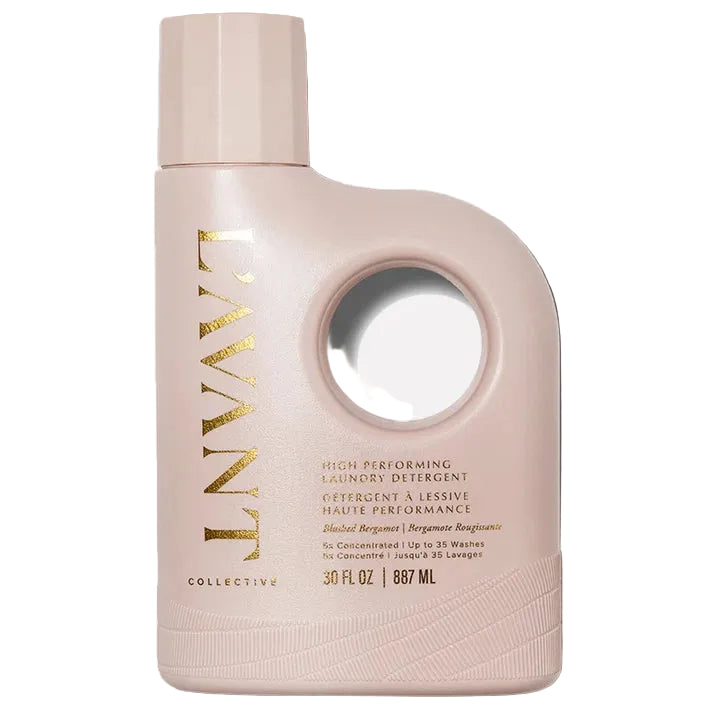 Pink bottle of laundry detergent with gold text on a white background