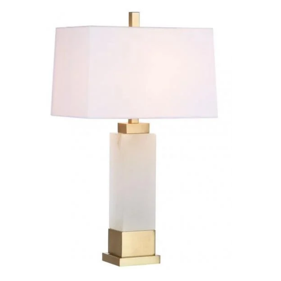 A modern table lamp featuring a square white frosted glass base, a brushed gold metal accent at the neck and bottom, and a white fabric drum shade, shown against a plain white background.