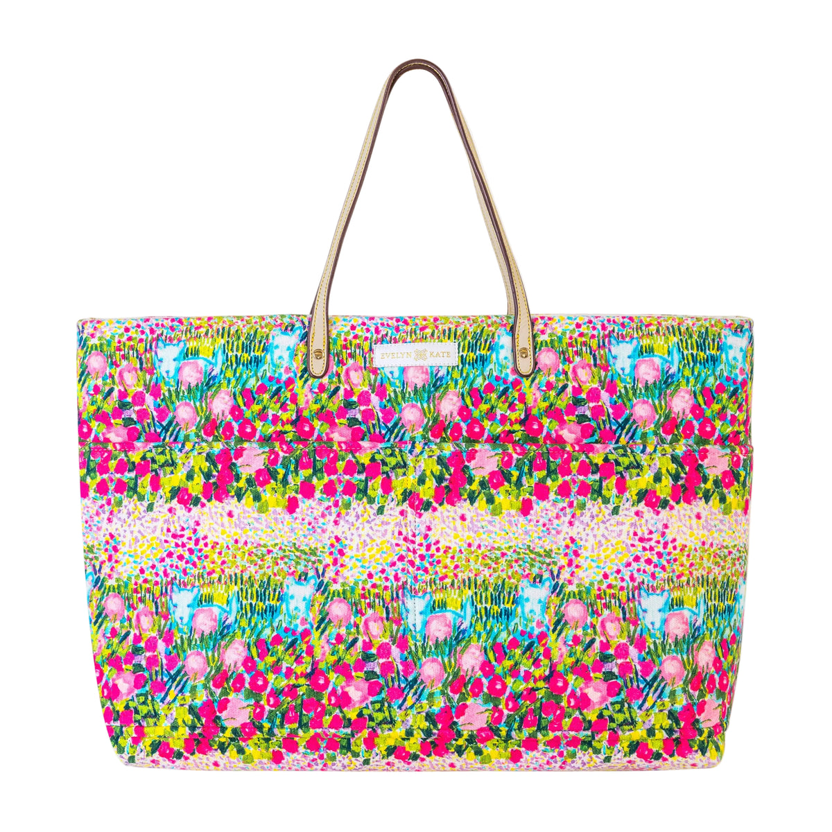 A large tote bag featuring Westie pups and a vibrant, colorful floral and botanical print with pink, green, yellow, and blue tones, complete with tan shoulder straps on a solid white background.