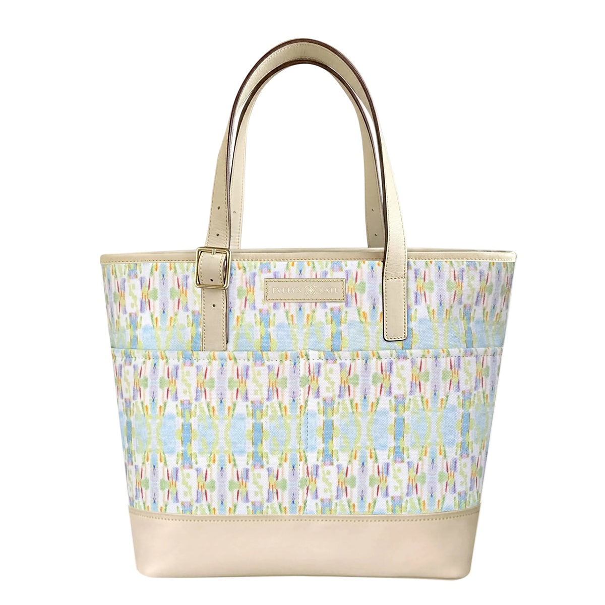 A structured tote bag with a pastel ikat pattern on the upper body and a solid beige leather base and handles, shown against a plain white background.