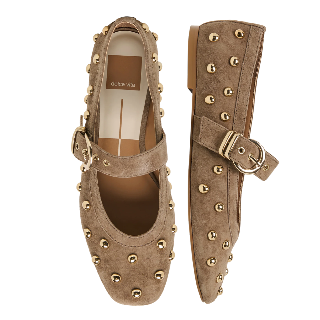 A pair of olive suede Mary Jane flats decorated with gold-tone studs and buckle straps, shown from top and side views on a white background.