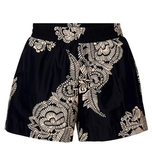 Black shorts with a beige floral lace overlay, featuring a drawstring waist and a front button closure, shown against a plain white background.