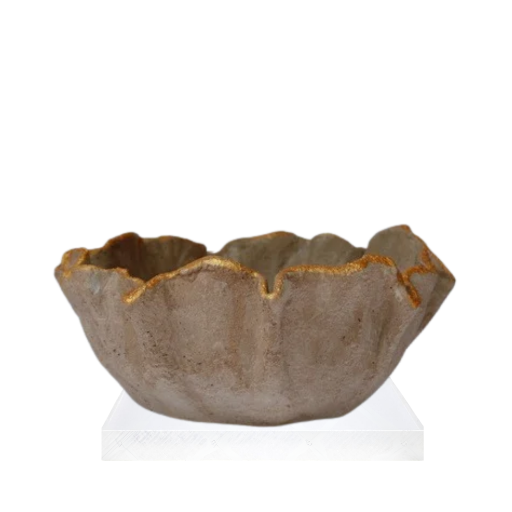 A small handmade ceramic bowl with a scalloped, flower-like rim, featuring a textured earthy brown glaze and a thin gold metallic trim along the edge, displayed on a white pedestal against a white background.