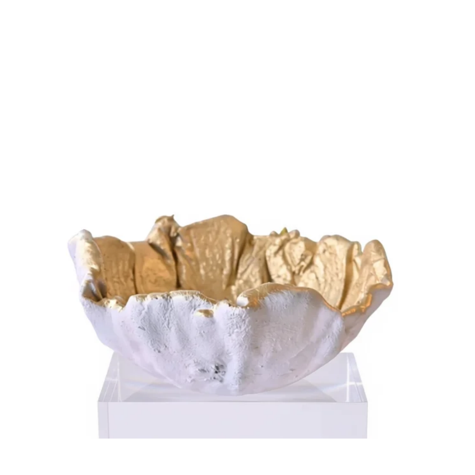 A decorative bowl with a textured white exterior and shimmering gold interior, displayed on a clear acrylic stand against a solid white background.