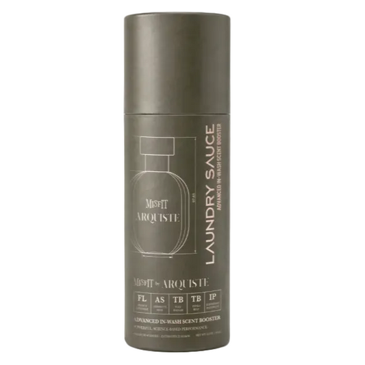 A matte dark gray cylindrical bottle of Misfit by Arquiste Laundry Sauce, featuring a minimalist line-art bottle graphic and text, set against a clean white background.