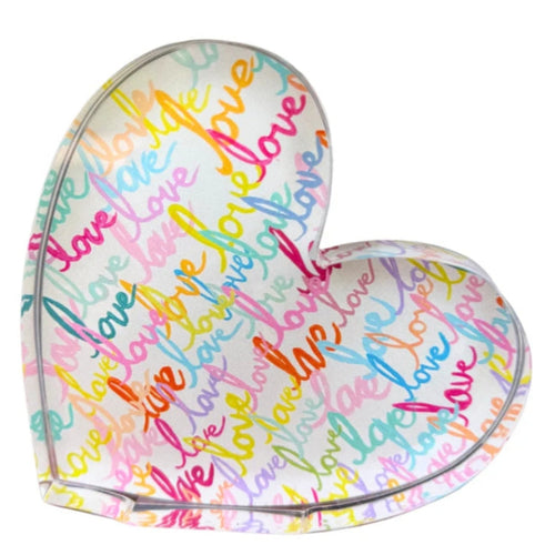 Heart-shaped cushion with 'love' text in various colors on a white background