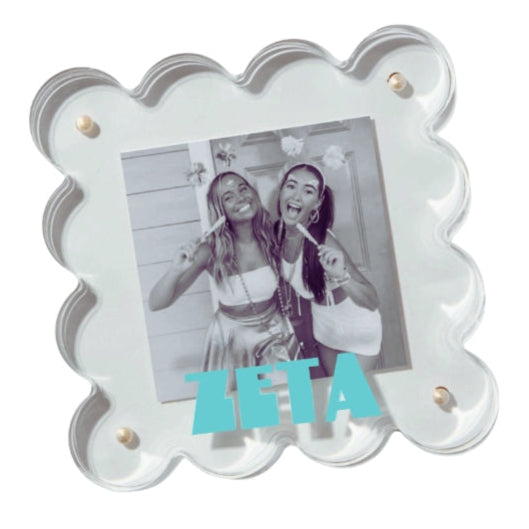 Decorative photo frame with a picture of two people and the word 'ZETA' on a white background