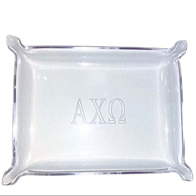 Clear square glass tray with 'AXO' engraving on a white background