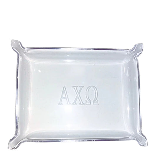 Clear square glass tray with 'AXO' engraving on a white background