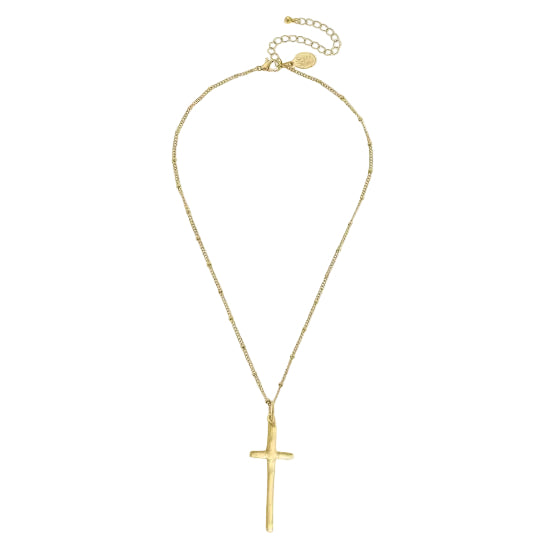 A gold cross pendant necklace with a delicate chain and extender clasp, shown on a white background with a side panel of a model wearing it.
