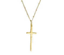 A gold cross pendant necklace with a delicate chain and extender clasp, shown on a white background with a side panel of a model wearing it.