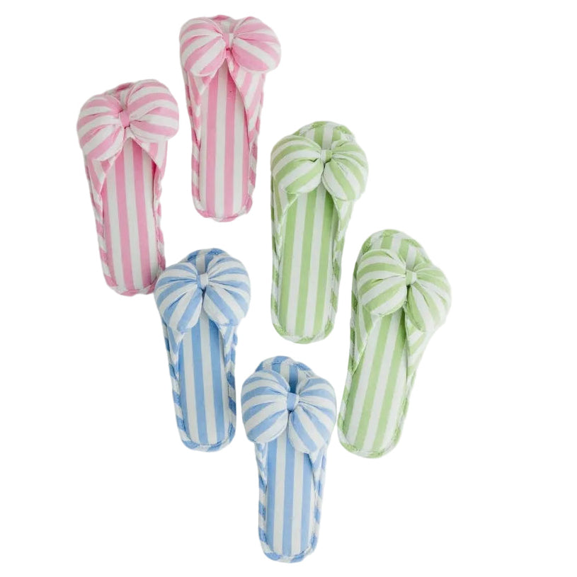 Four soft fabric flip-flop style slippers with large bow details, shown in pink, green, and blue vertical stripe patterns on a white background.