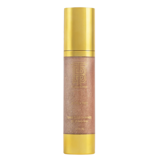 A cylindrical cosmetic bottle with a metallic gold cap and base, featuring a shimmering rose-gold/champagne liquid inside, centered on a plain white background.