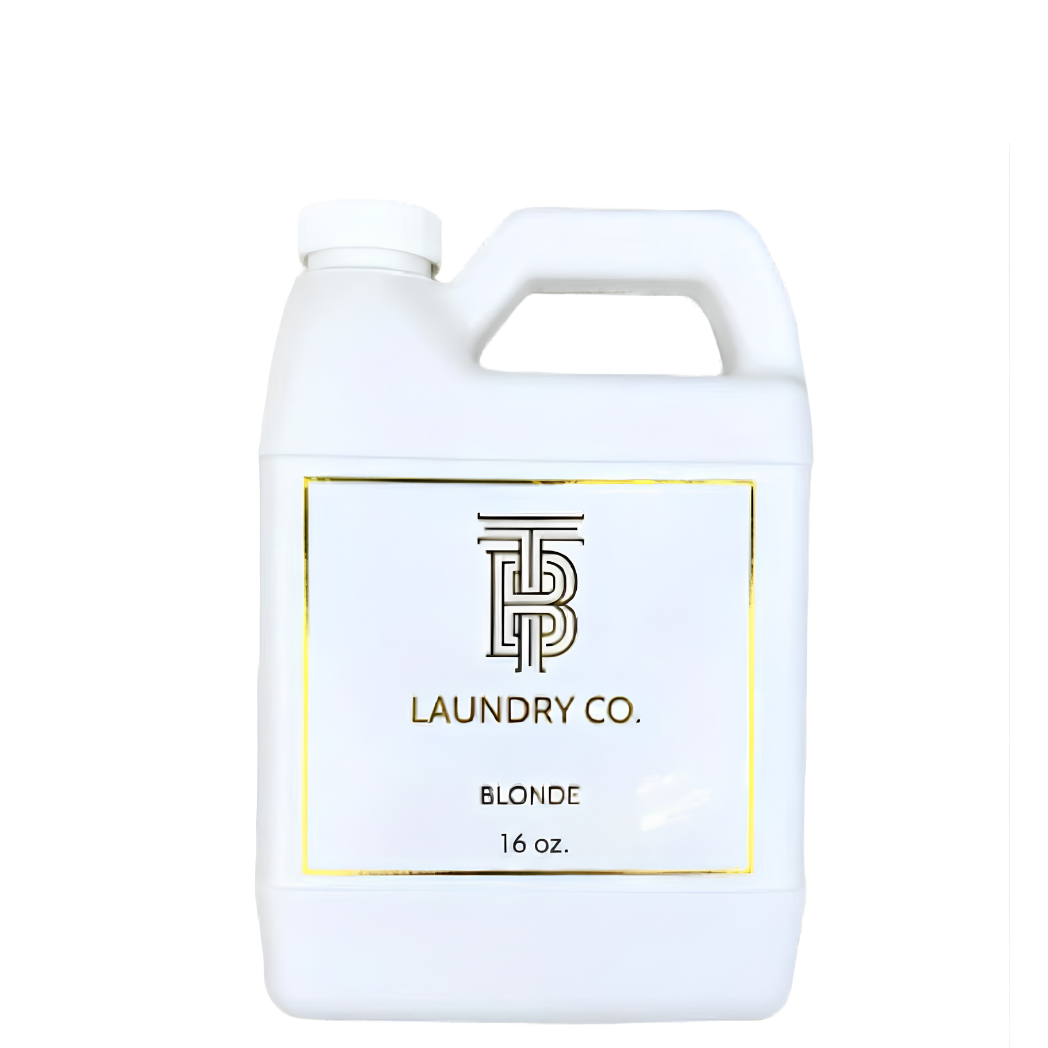 A white plastic laundry detergent jug with a handle and a white label featuring a gold border and the brand name 'TP Laundry Co.' on a plain white background.
