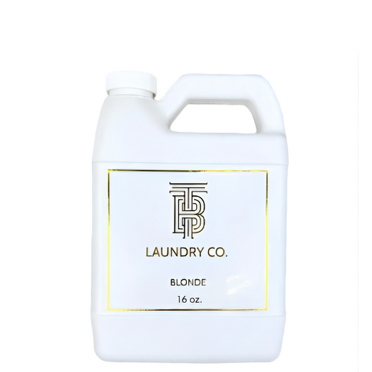 A white plastic laundry detergent jug with a handle and a white label featuring a gold border and the brand name 'TP Laundry Co.' on a plain white background.