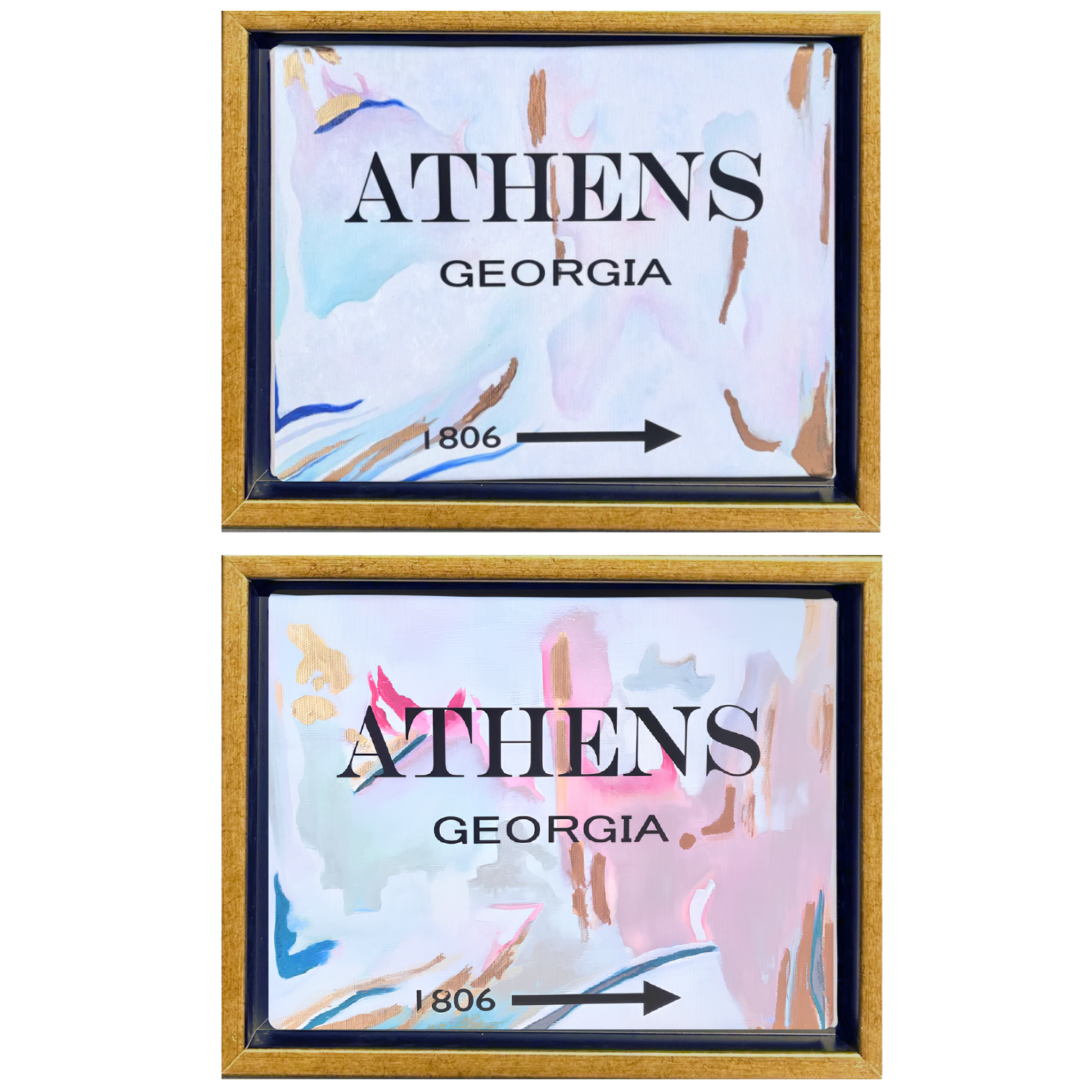 Two framed art prints featuring a watercolor-style abstract design in pastel shades of pink, blue, and white, with gold frames. Each print displays the text 'ATHENS GEORGIA' and '1806' with a directional arrow.