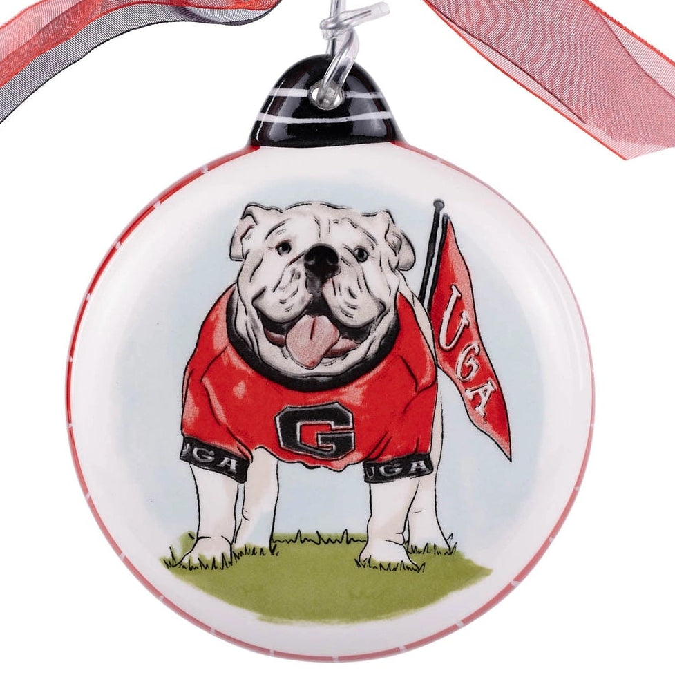 Decorative ornament with a bulldog wearing a red jacket and 'UGA' flag, hanging from a ribbon.