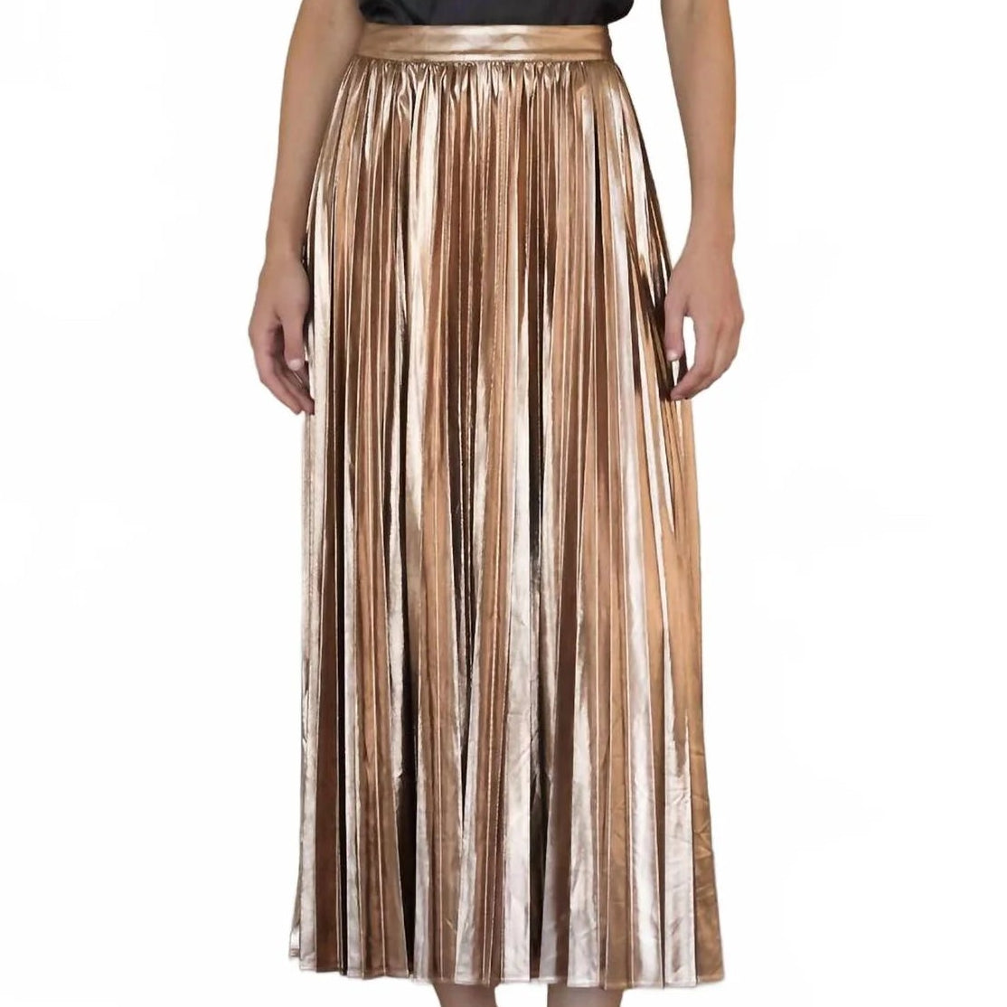 A model wearing a sleeveless black satin top with a lace neckline and a high-waisted, metallic rose gold pleated midi skirt, paired with black pointed-toe heels, against a plain white background.