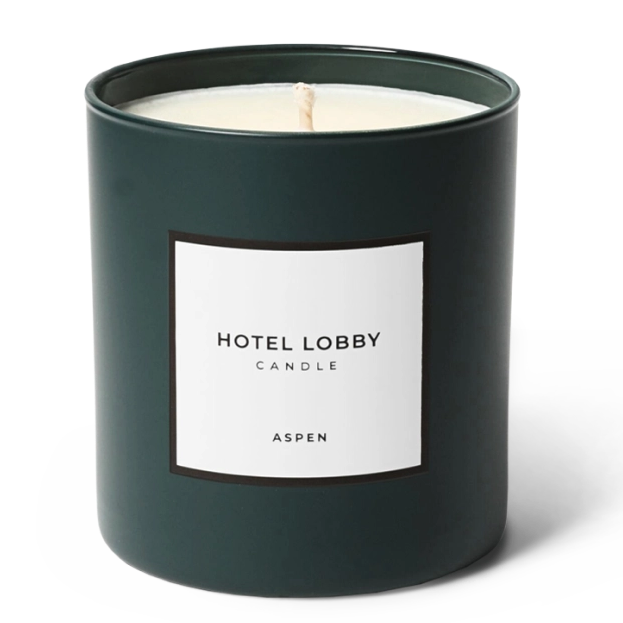 A dark green glass jar candle with a white label reading 'HOTEL LOBBY CANDLE' and 'ASPEN' on a clean white background.