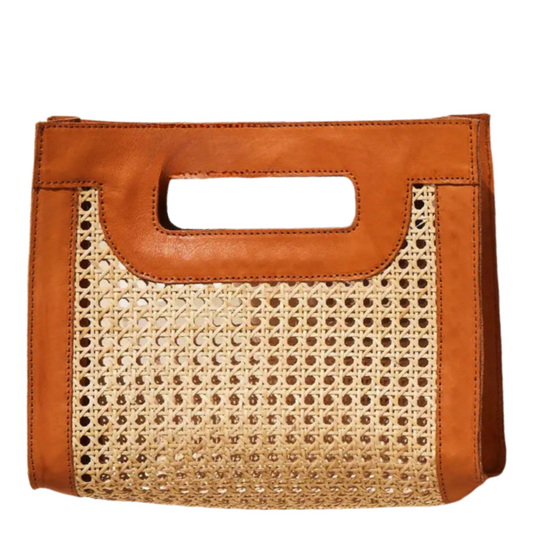 A structured tote bag featuring a natural woven cane front panel and smooth tan leather trim with a top handle cutout, shown against a plain white background.